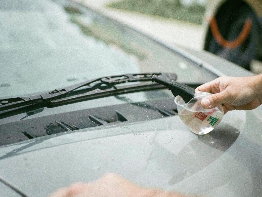 Windshield washer fluid being refilled